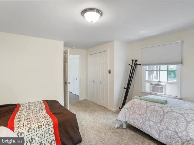 a bedroom with a large bed and wooden floor