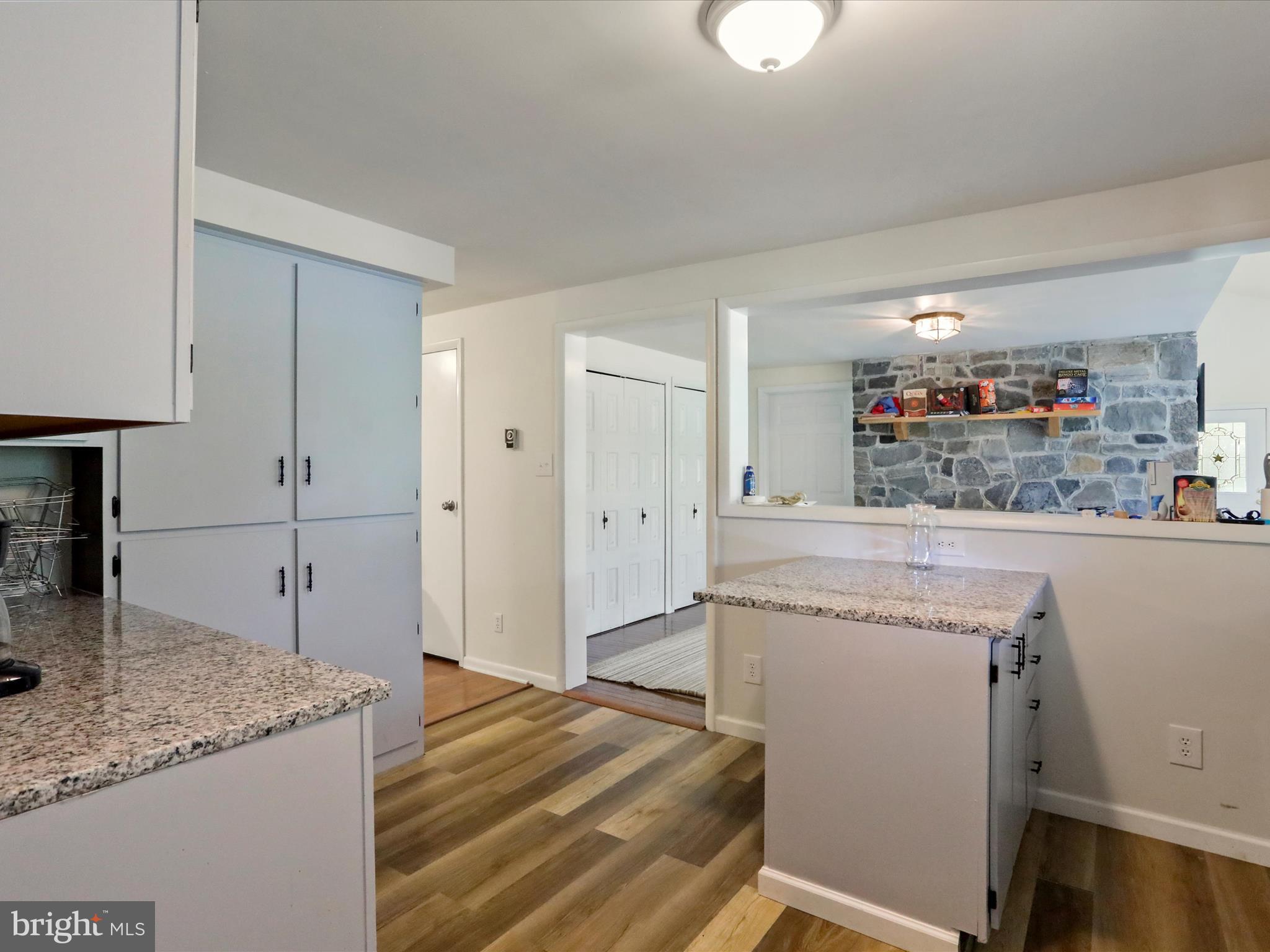 999 Aspero Lane Falling Waters, WV 25419 - Photo 23 of 57 a kitchen with granite countertop cabinets a sink and a refrigerator
