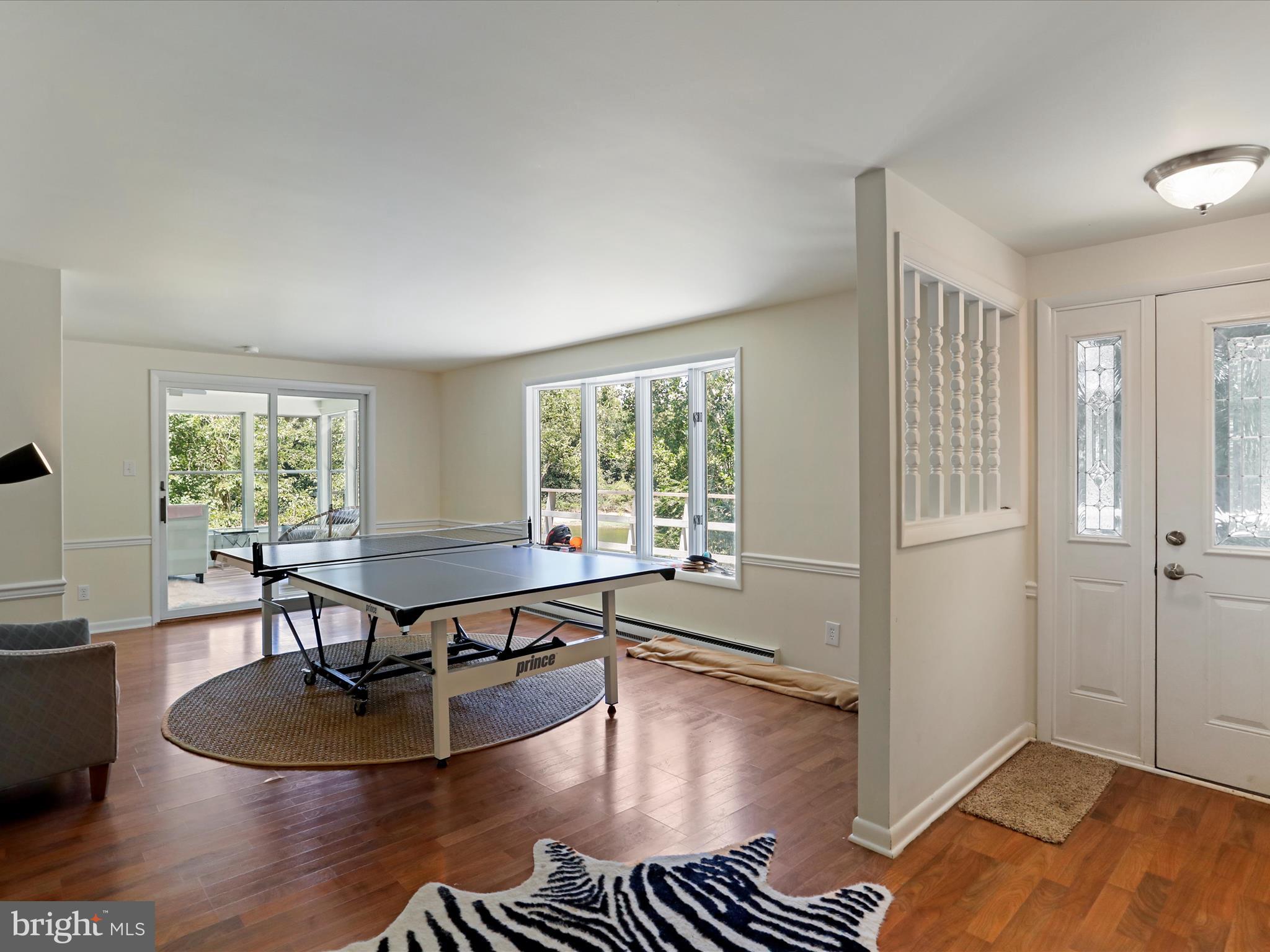 999 Aspero Lane Falling Waters, WV 25419 - Photo 25 of 57 a living room with furniture a large window and wooden floor