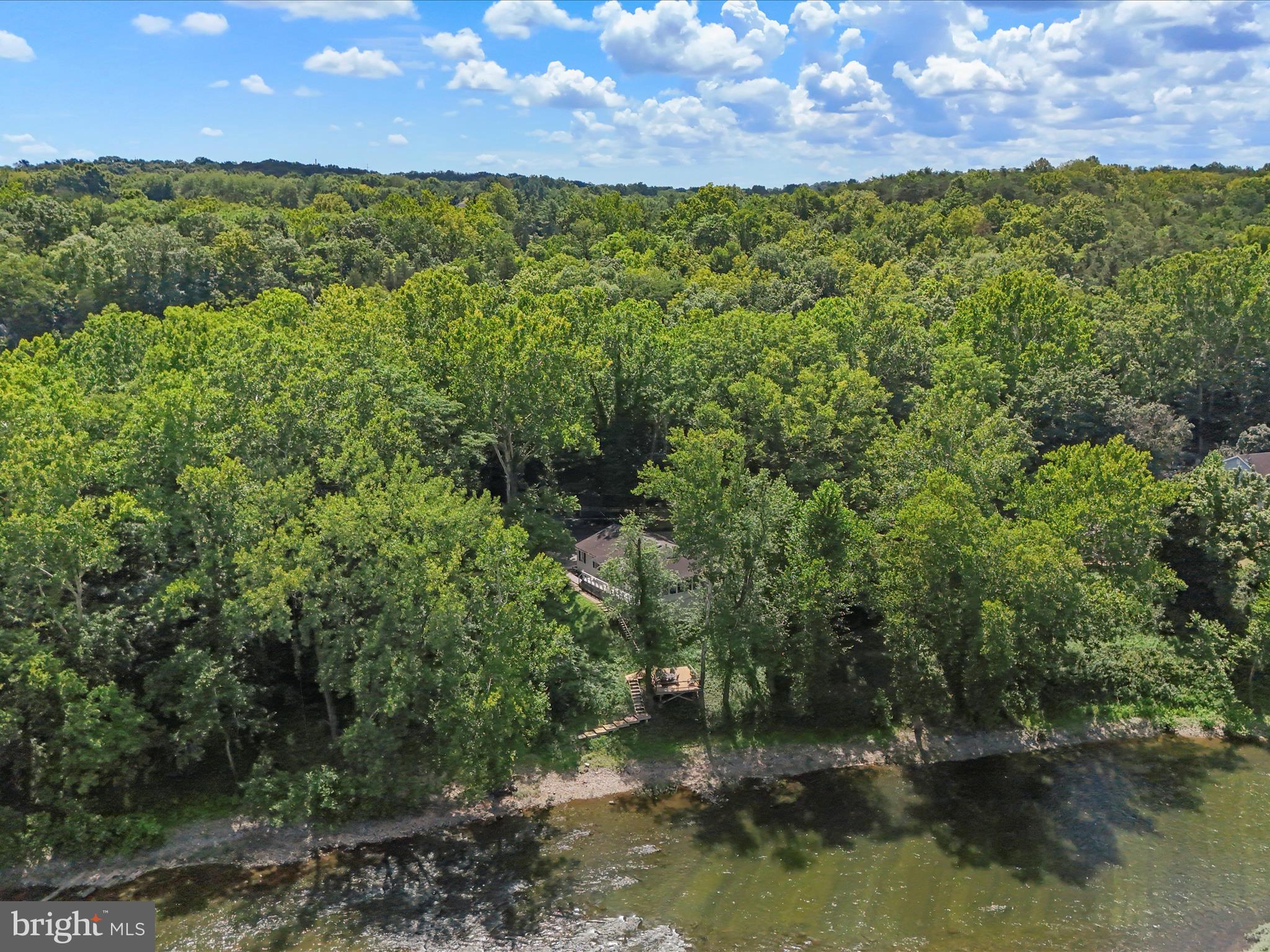 999 Aspero Lane Falling Waters, WV 25419 - Photo 50 of 57 a view of a lake with houses in the background
