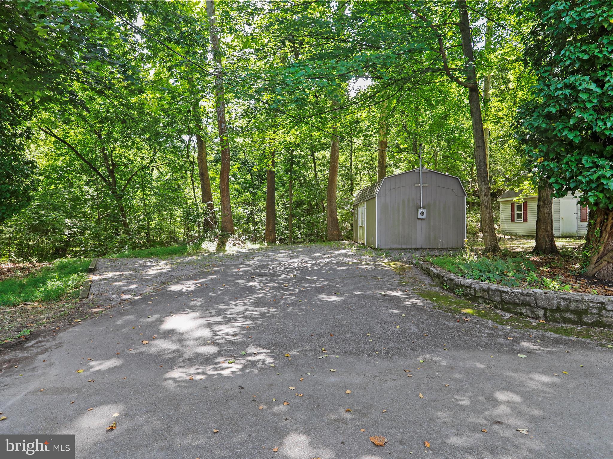 999 Aspero Lane Falling Waters, WV 25419 - Photo 9 of 57 a view of a big house with large trees