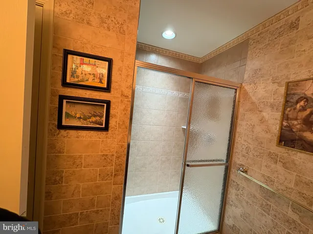 a bathroom with a sink a mirror and a shower