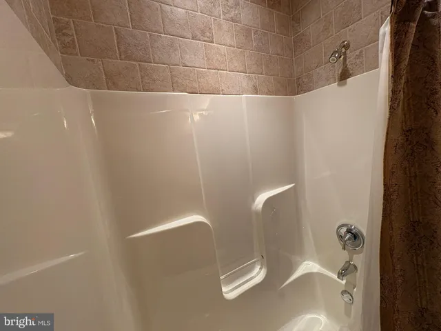 a bathroom with a sink a toilet a mirror and shower curtain