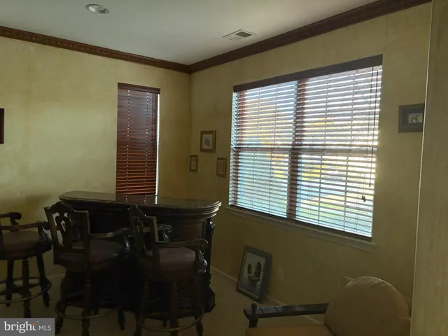 a room with chairs and a window