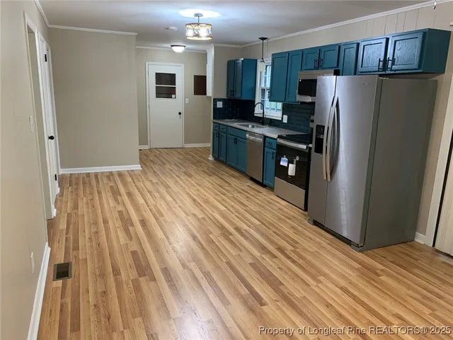 a kitchen with stainless steel appliances a refrigerator and a stove