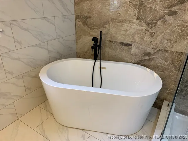 a white bath tub sitting in a bathroom