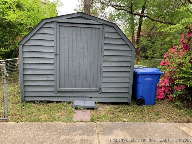 a backyard of a house with table and chairs