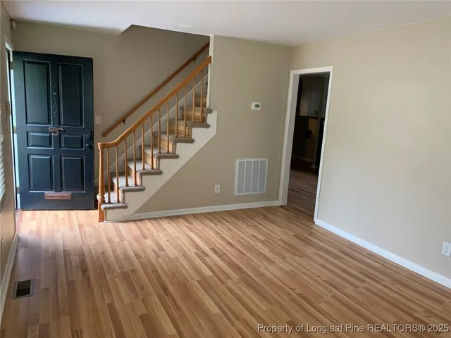 a view of entryway with wooden floor