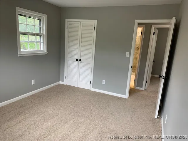 an empty room with windows and closet