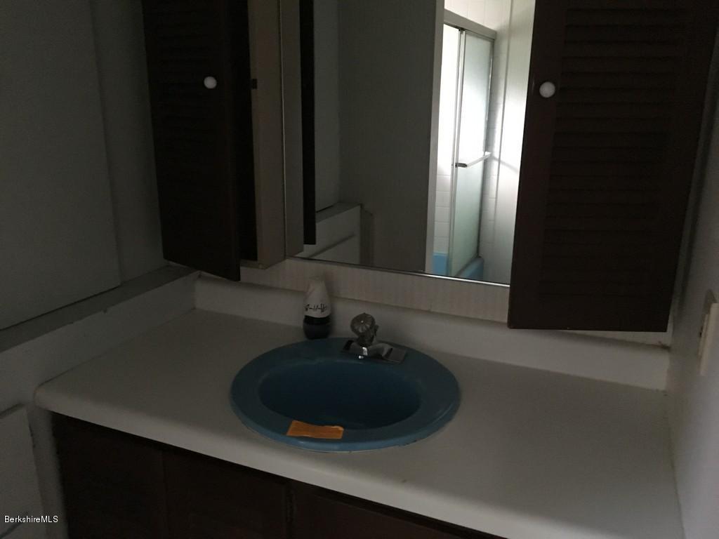 135 River Road Monroe, MA 01350 - Photo 8 of 21 a bathroom with a sink and a mirror