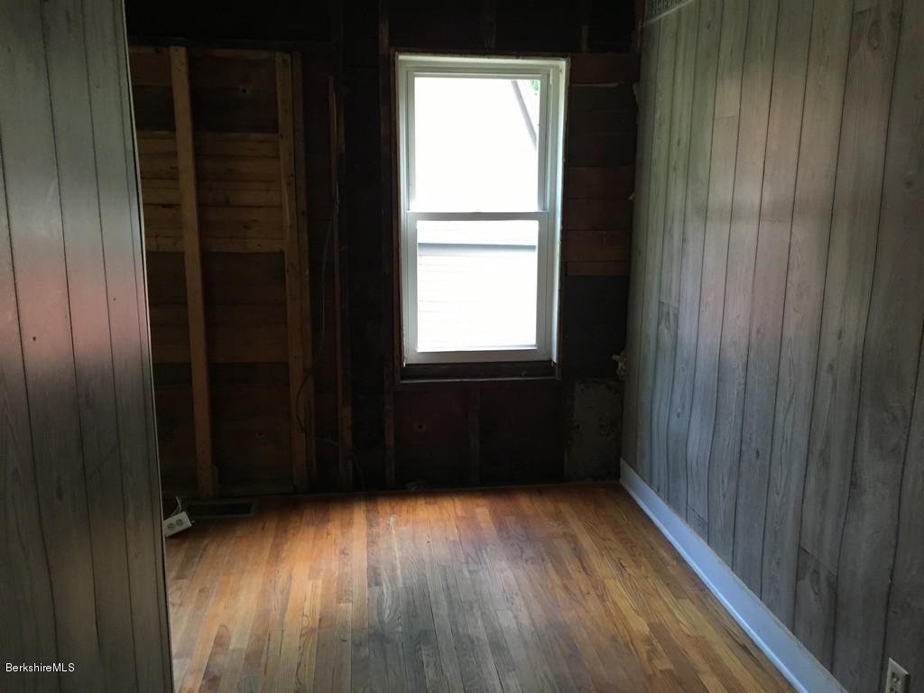 135 River Road Monroe, MA 01350 - Photo 9 of 21 a view of empty room with wooden floor and fan