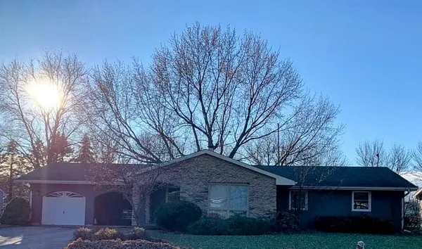 a front view of house with yard and trees