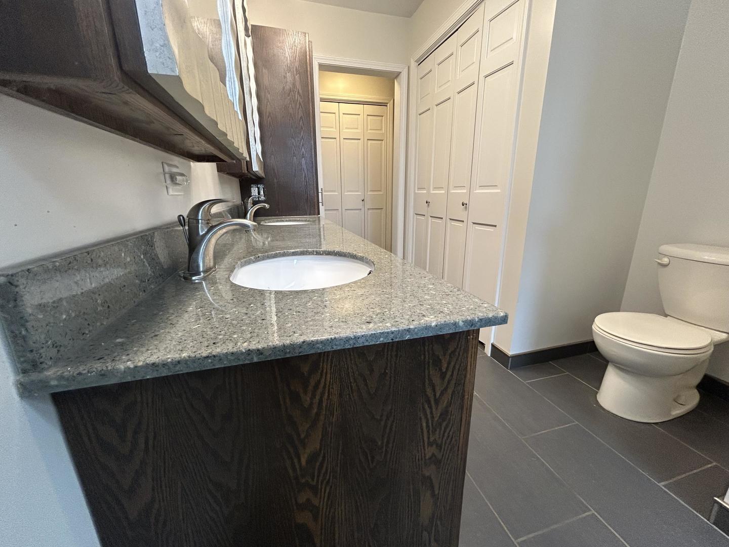 712 Kelley Drive Rochelle, IL 61068 - Photo 20 of 35 a bathroom with a granite countertop sink and a toilet