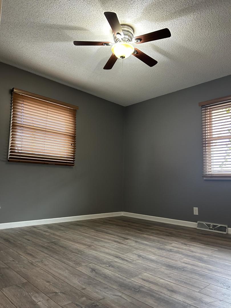 712 Kelley Drive Rochelle, IL 61068 - Photo 32 of 35 a view of empty room with wooden floor and fan
