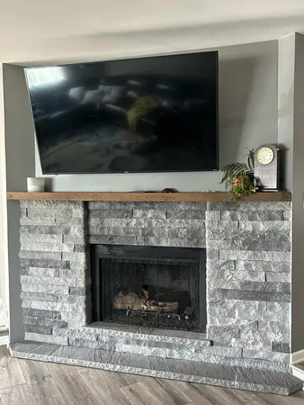 a living room with a fireplace and a fireplace
