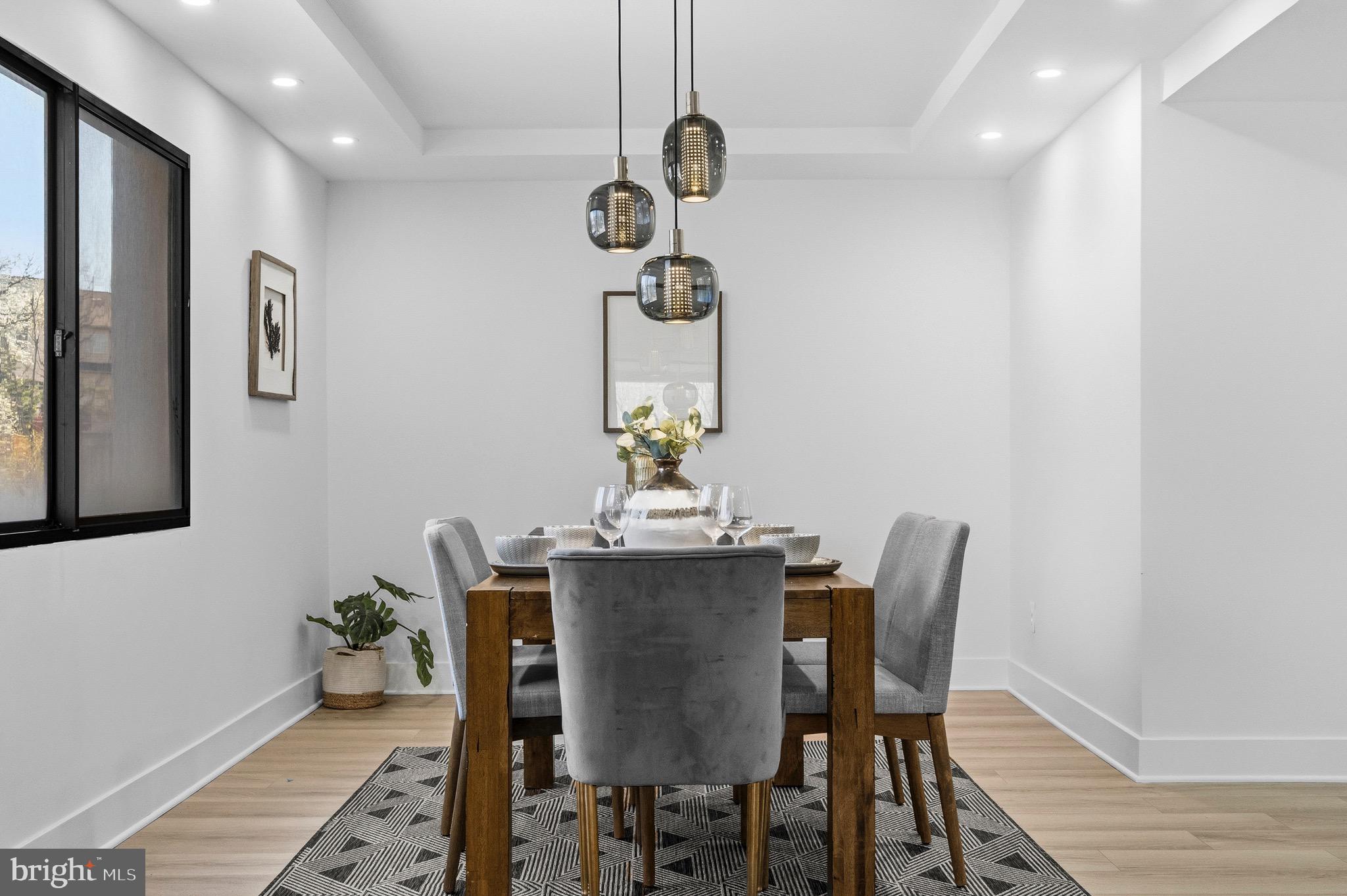 6101 Edsall Road, Unit 602 Alexandria, VA 22304 - Photo 13 of 38 a view of a dining room with furniture wooden floor and a chandelier