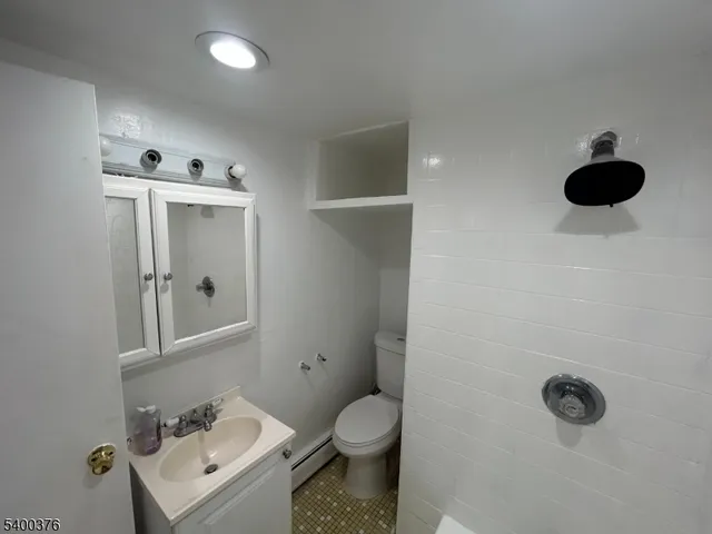 a bathroom with a toilet sink and shower