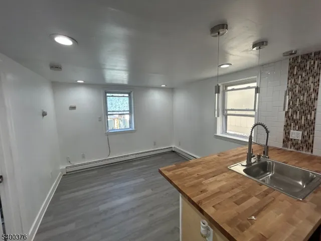 a kitchen with kitchen island a sink window and wooden floor