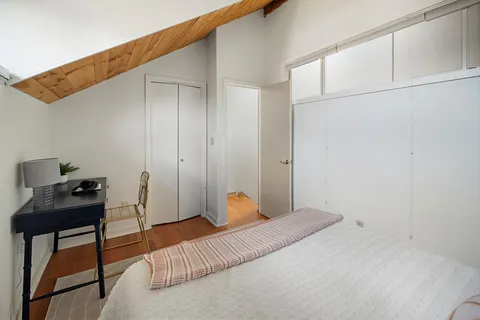 a bedroom with a bed and a desk