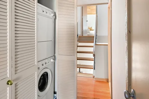 a view of a hallway with washer and dryer