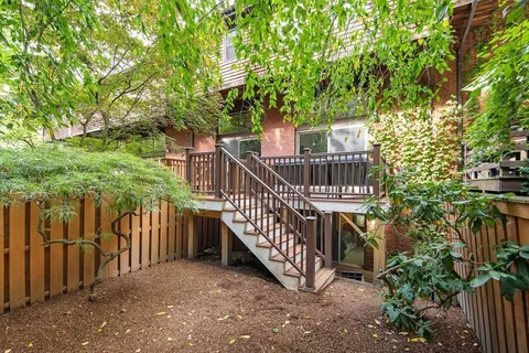 a view of a yard with wooden deck