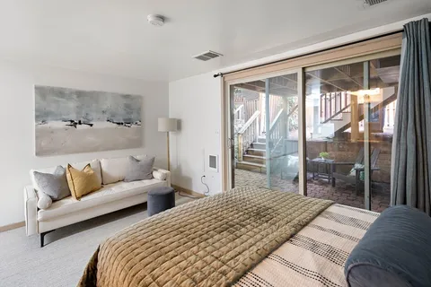 a bedroom with a large bed and a large window