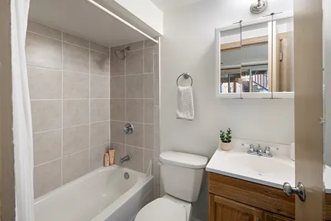 a bathroom with a sink a toilet and bathtub