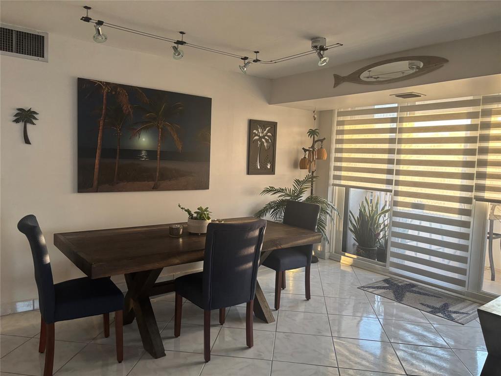 1370 South Ocean Boulevard, Unit 1005 Pompano Beach, FL 33062 - Photo 12 of 27 a dining room with furniture and window