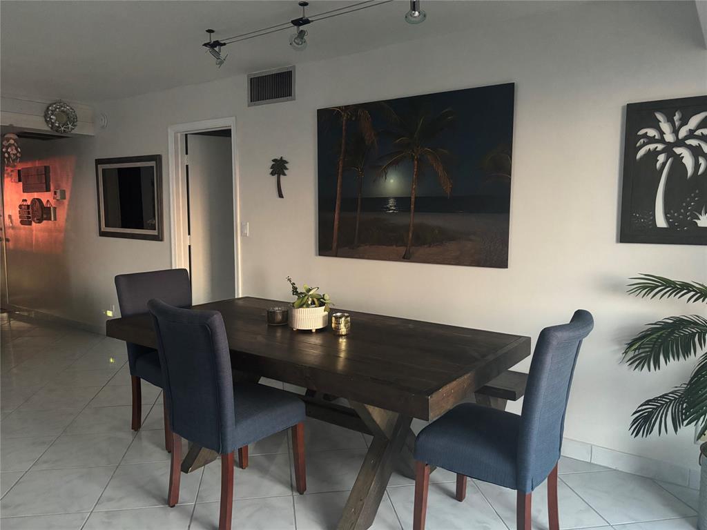 1370 South Ocean Boulevard, Unit 1005 Pompano Beach, FL 33062 - Photo 13 of 27 a dining room with furniture and window
