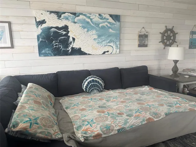 a view of a livingroom with workspace and a window