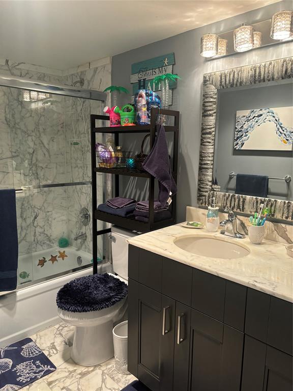 1370 South Ocean Boulevard, Unit 1005 Pompano Beach, FL 33062 - Photo 21 of 27 a bathroom with a sink a toilet and a mirror