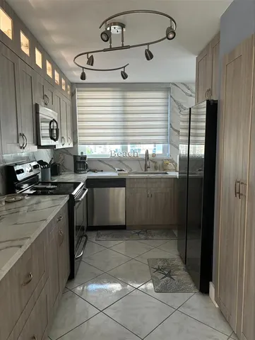 a spacious bathroom with a granite countertop sink and a mirror