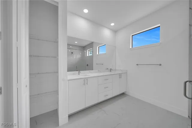 an empty room with a ceiling fan and window