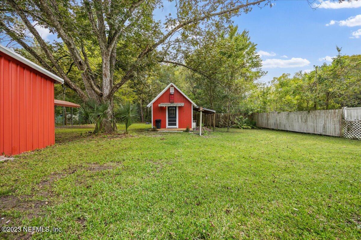 9006 Marlee Road Jacksonville, FL 32222 - Photo 13 of 18 a view of backyard of house with green space