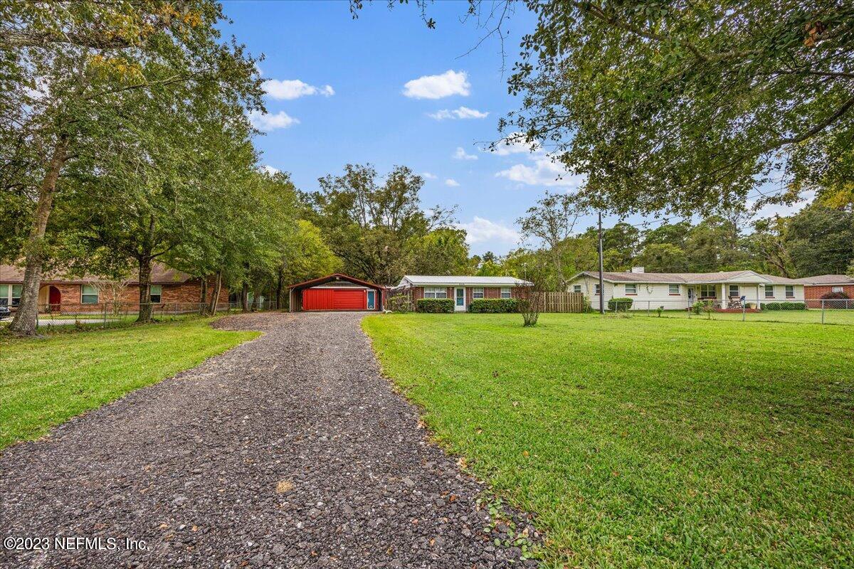 9006 Marlee Road Jacksonville, FL 32222 - Photo 2 of 18 a front view of a house with a yard