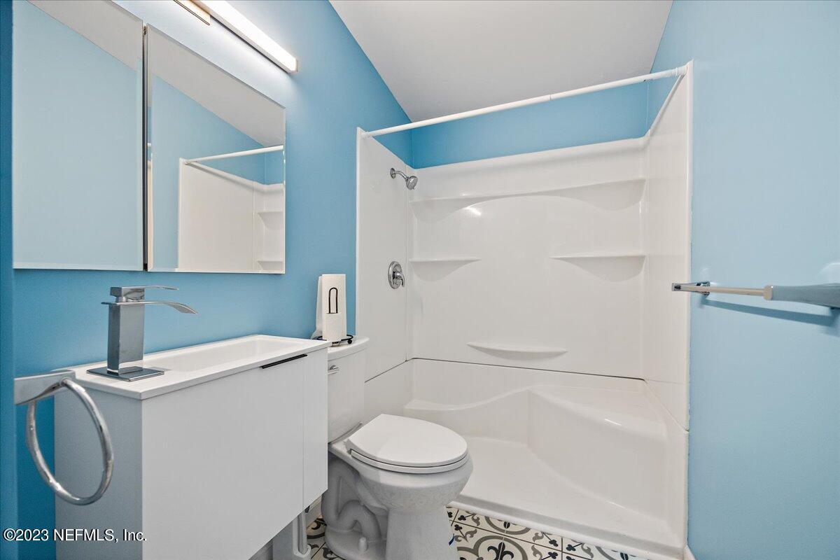 9006 Marlee Road Jacksonville, FL 32222 - Photo 8 of 18 a bathroom with a sink a toilet and shower