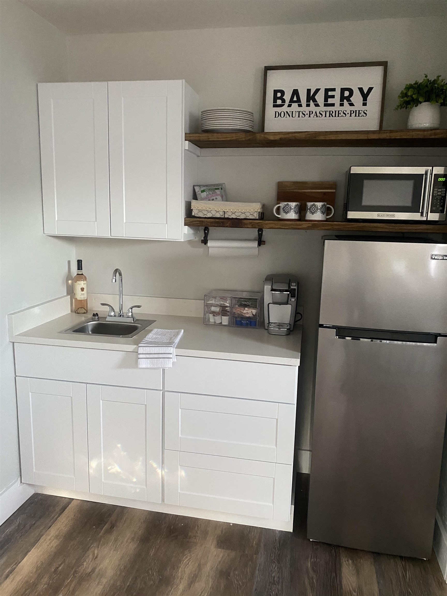 147 Swallow Road St. Augustine, FL 32086 - Photo 24 of 26 a kitchen with a refrigerator and cabinets