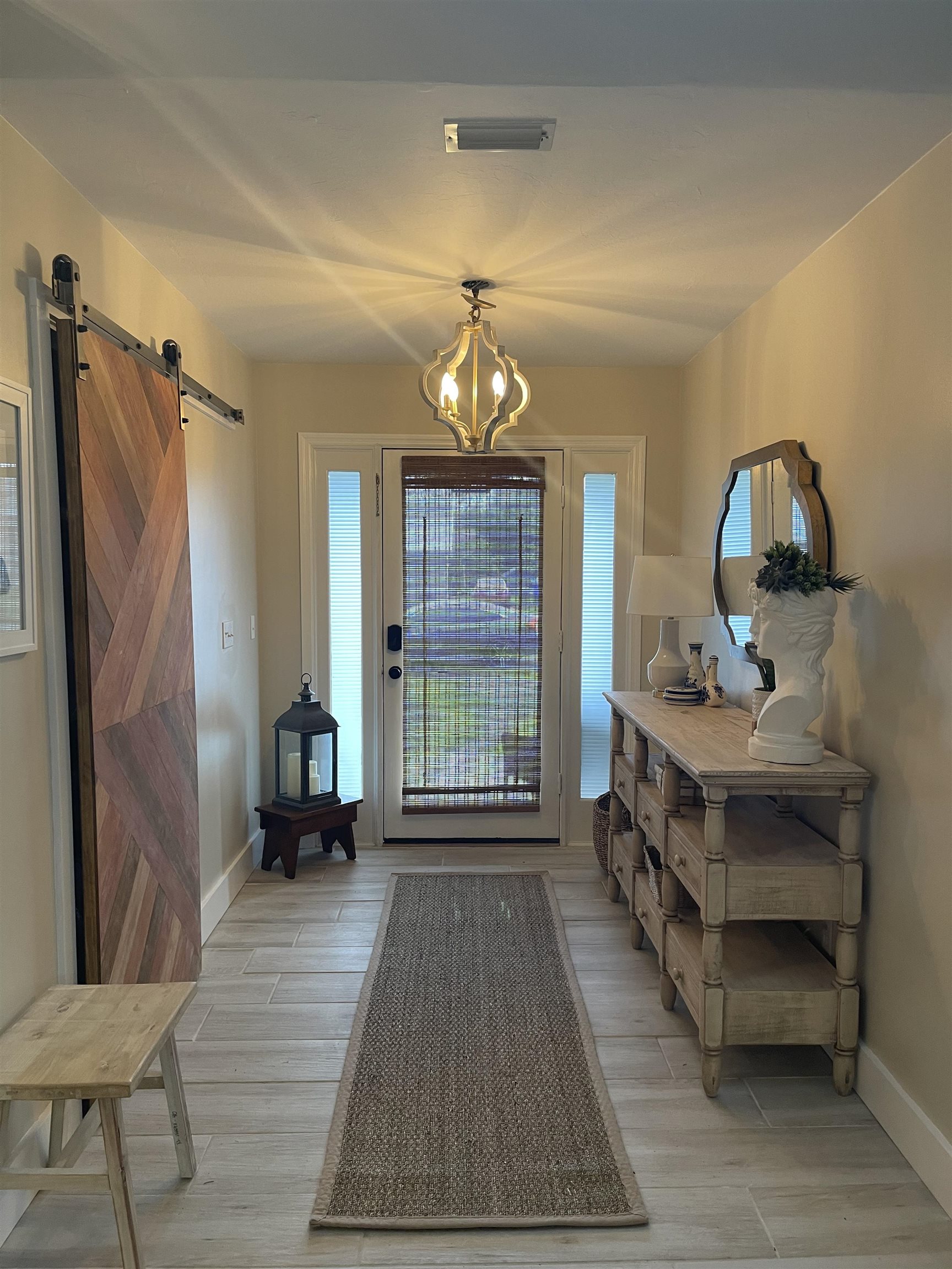 147 Swallow Road St. Augustine, FL 32086 - Photo 3 of 26 a bedroom with a bed and a chandelier