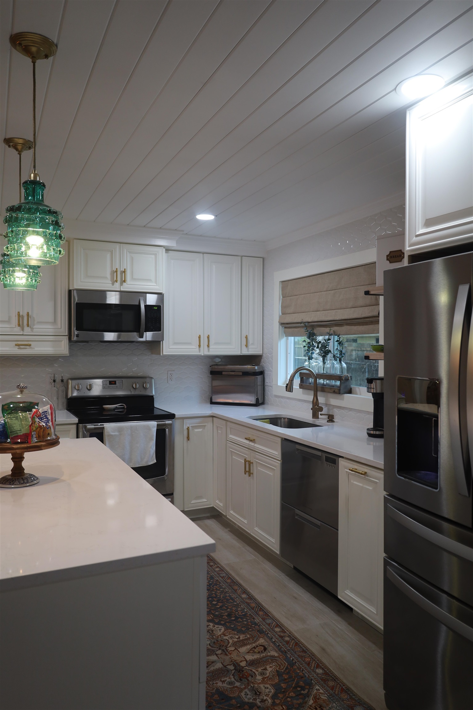 147 Swallow Road St. Augustine, FL 32086 - Photo 6 of 26 a kitchen with stainless steel appliances a sink a stove a microwave and cabinets