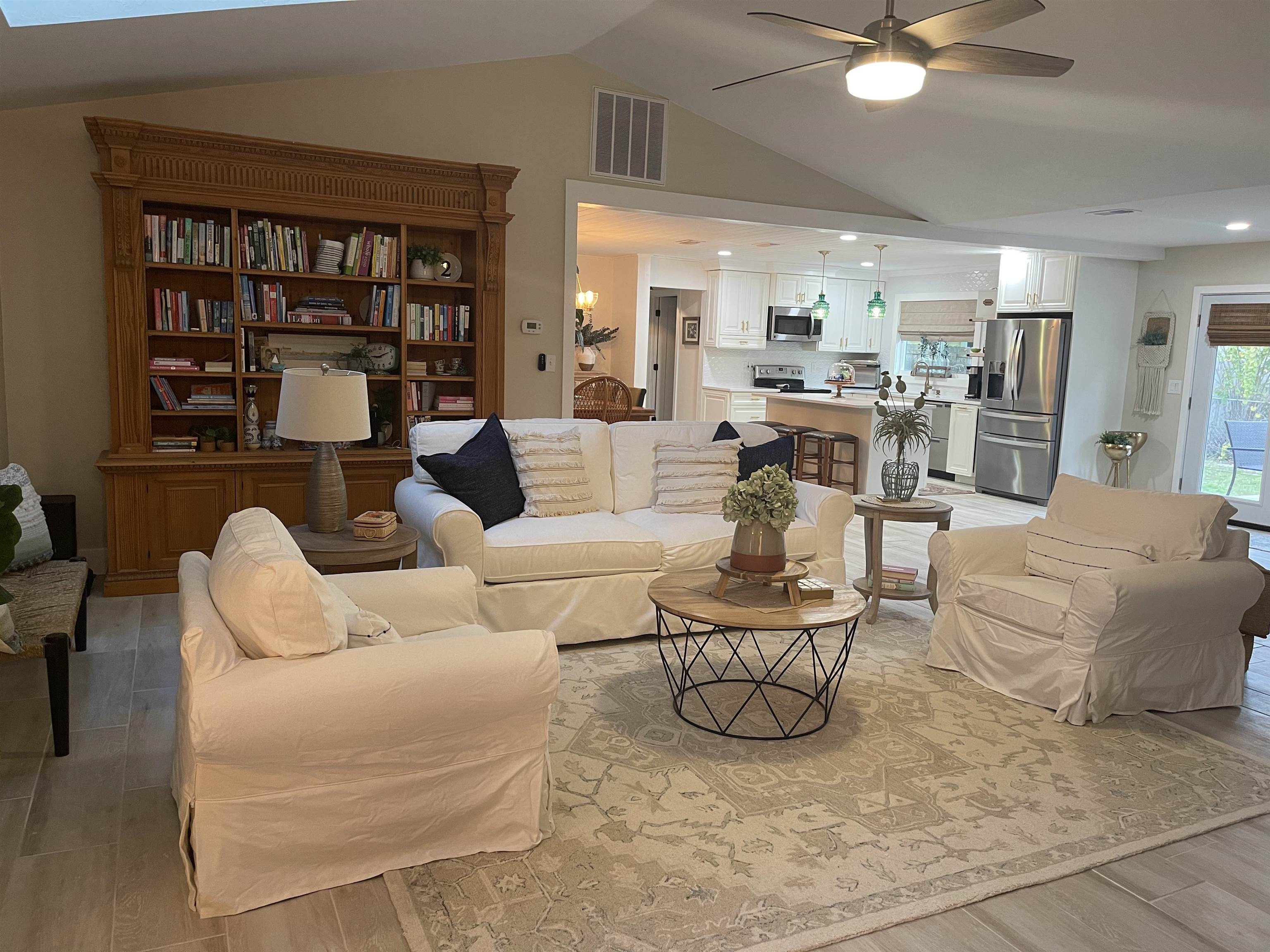 147 Swallow Road St. Augustine, FL 32086 - Photo 10 of 26 a living room with furniture a rug and a book shelf
