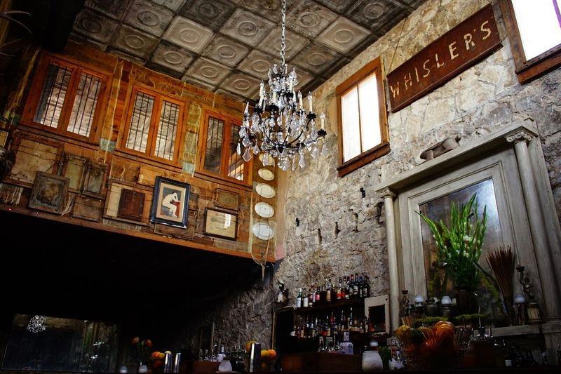 2002 East 9th Street, Unit 2 Austin, TX 78702 - Photo 29 of 32 Ornate ceiling tiles crown this unique space, illuminated by a glittering chandelier.