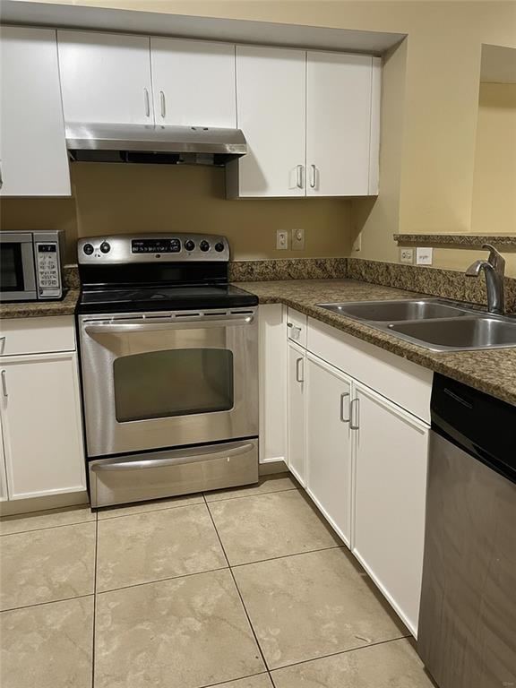 4816 Highway 7, Unit 11203 Coconut Creek, FL 33073 - Photo 1 of 35 a kitchen with granite countertop a stove a sink and a microwave