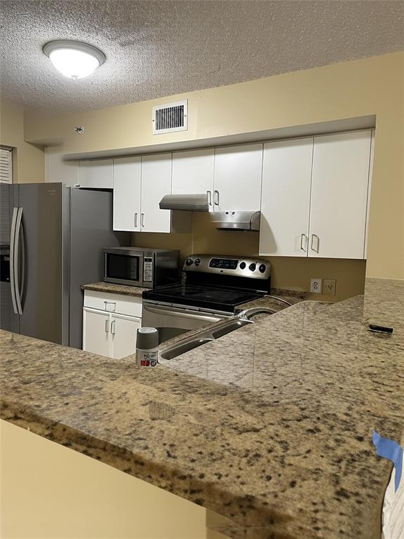4816 Highway 7, Unit 11203 Coconut Creek, FL 33073 - Photo 2 of 35 a kitchen with stainless steel appliances a refrigerator a stove and a sink