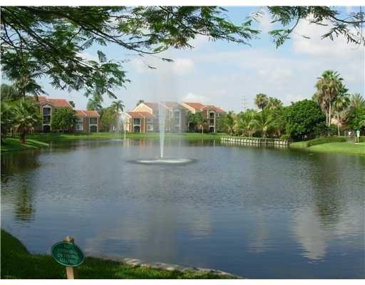 4816 Highway 7, Unit 11203 Coconut Creek, FL 33073 - Photo 26 of 35 a view of a lake with houses