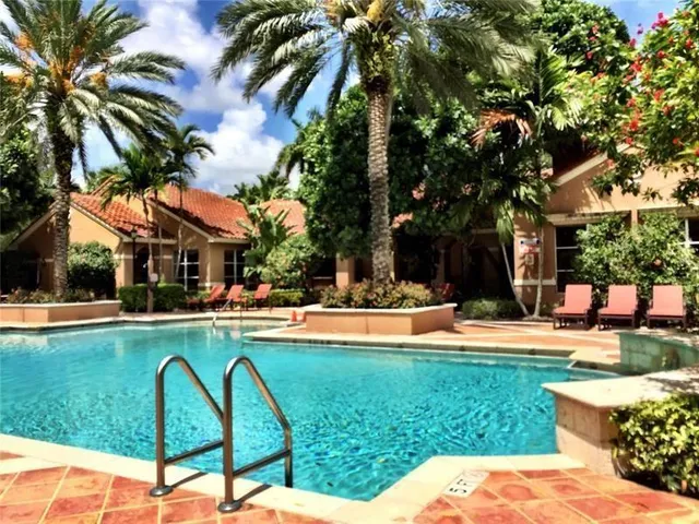 a view of a house with swimming pool and sitting area