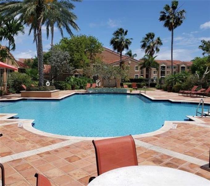 4816 Highway 7, Unit 11203 Coconut Creek, FL 33073 - Photo 32 of 35 a view of outdoor space with swimming pool and patio