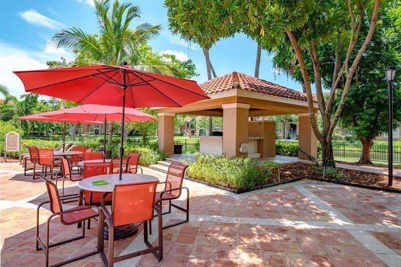 4816 Highway 7, Unit 11203 Coconut Creek, FL 33073 - Photo 34 of 35 a view of a house with backyard sitting area and garden