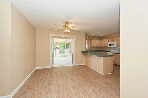 a view of kitchen with wooden floor and electronic appliances