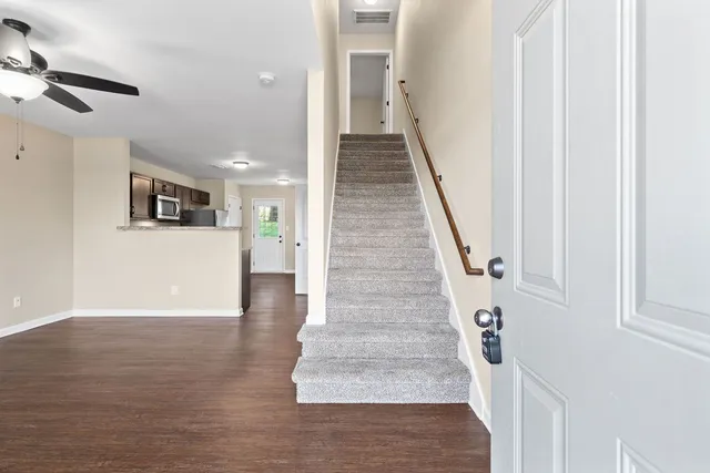 a view of entryway and hall with wooden floor
