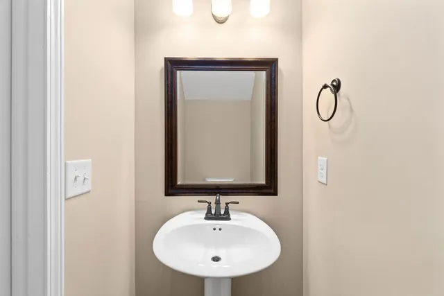 a bathroom with a sink a mirror and shower